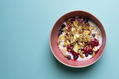 A colorful array of fresh fruit and crunchy toppings ready to customize frozen yogurt.