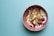 A refreshing yogurt bowl topped with tropical fruits and nuts.