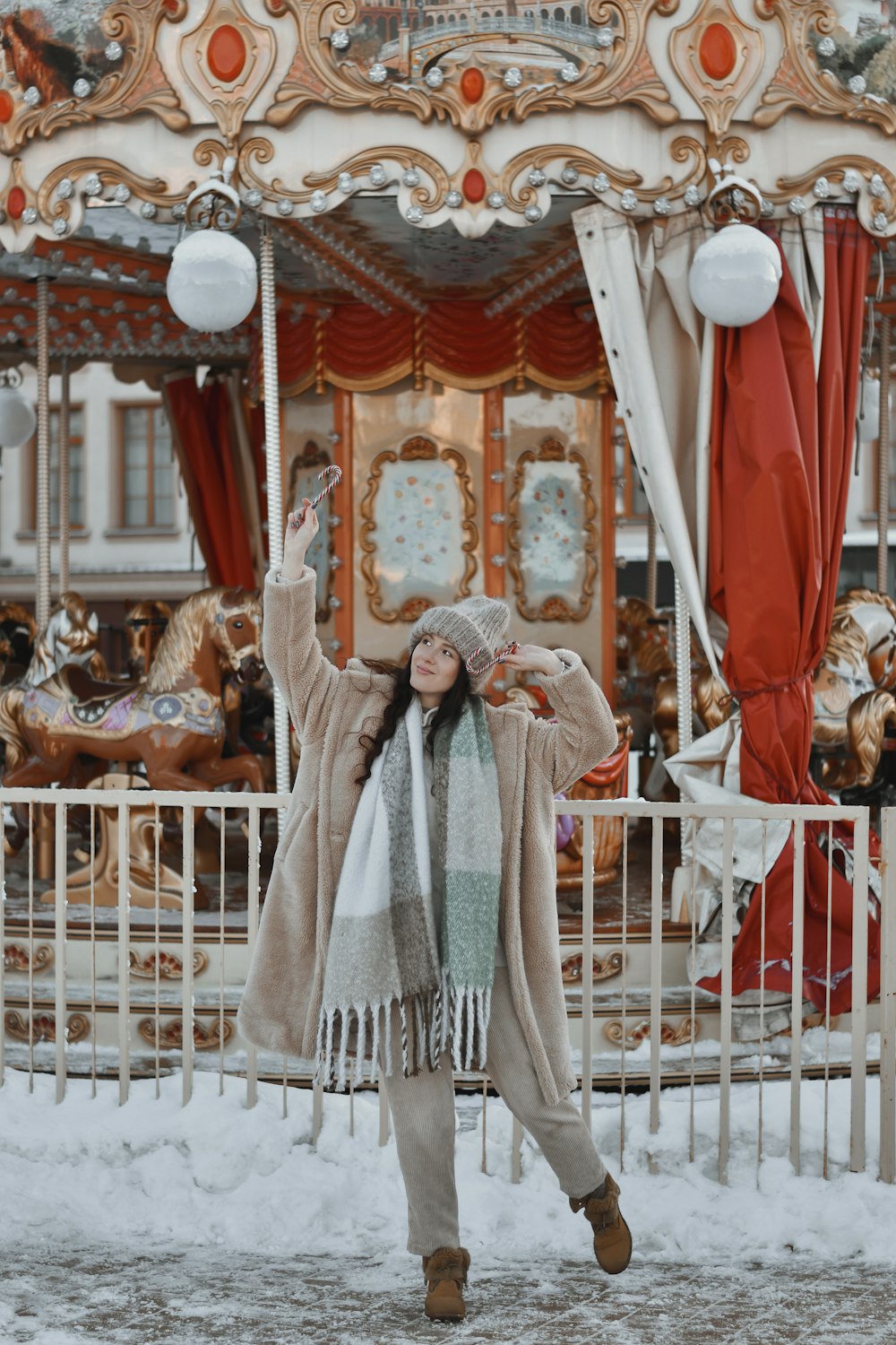 a woman standing in front of a merry go round