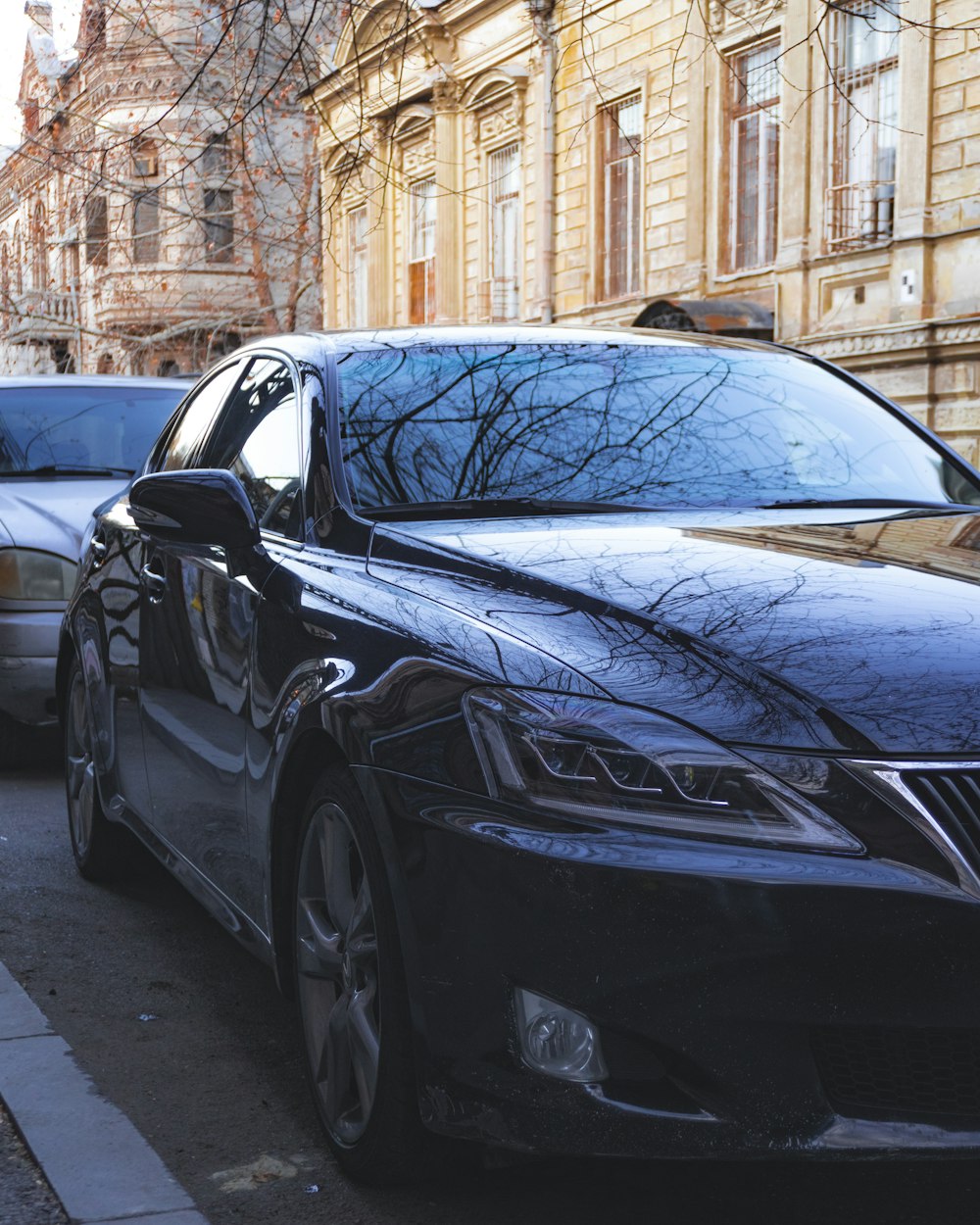 a couple of cars parked next to each other on a street