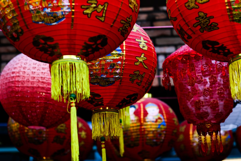 a group of red lanterns hanging from a ceiling