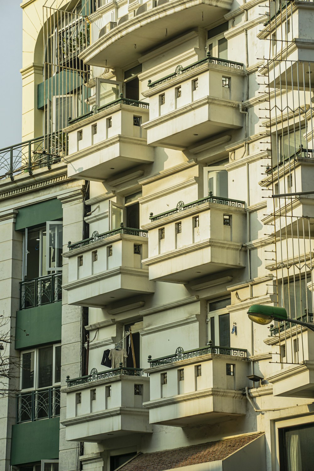 a tall building with lots of balconies on top of it