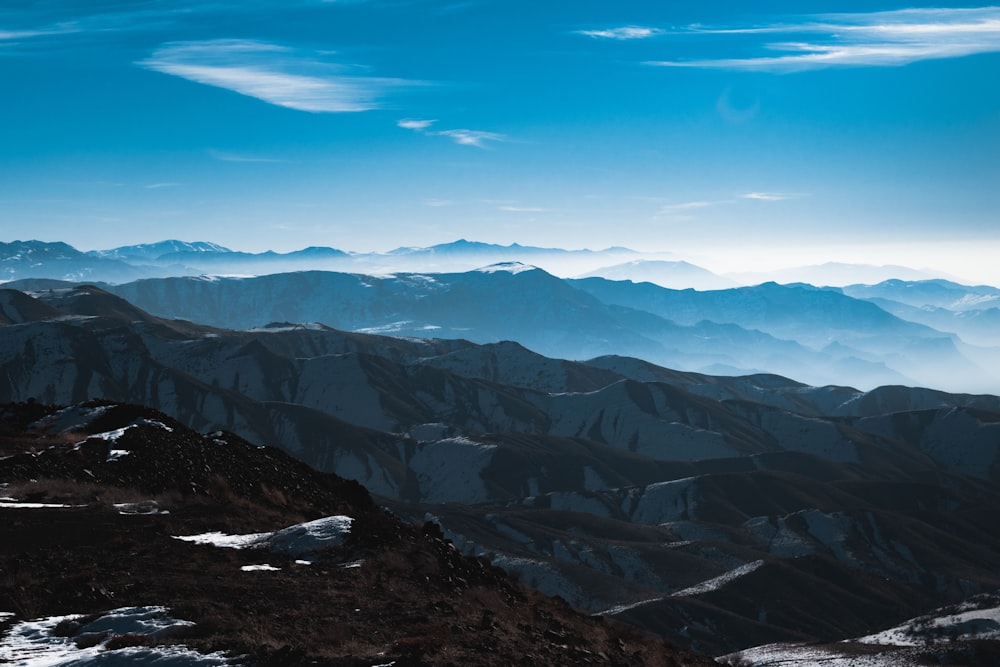 a view of a mountain range from the top of a mountain