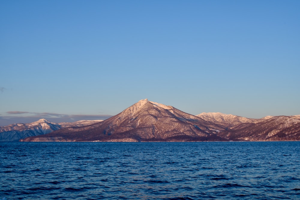 a large body of water with mountains in the background