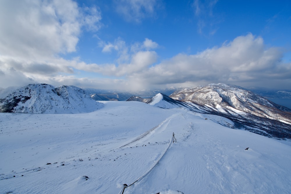 a snow covered mountain with a sky background