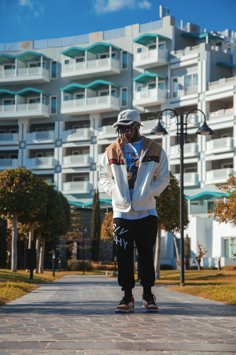 a person standing on a sidewalk with a skateboard