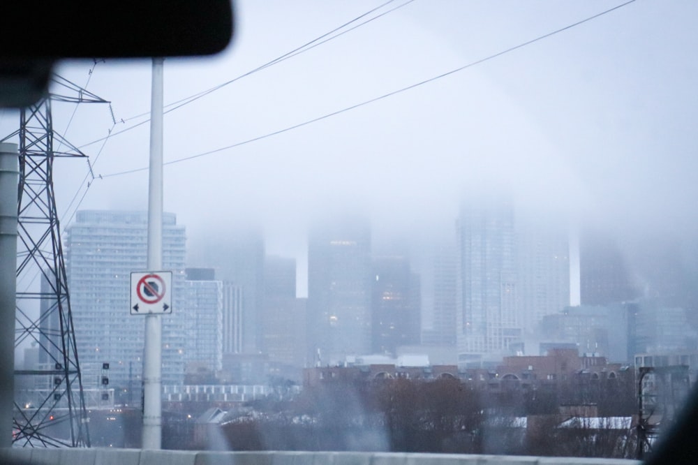 a foggy view of a city from a bus window