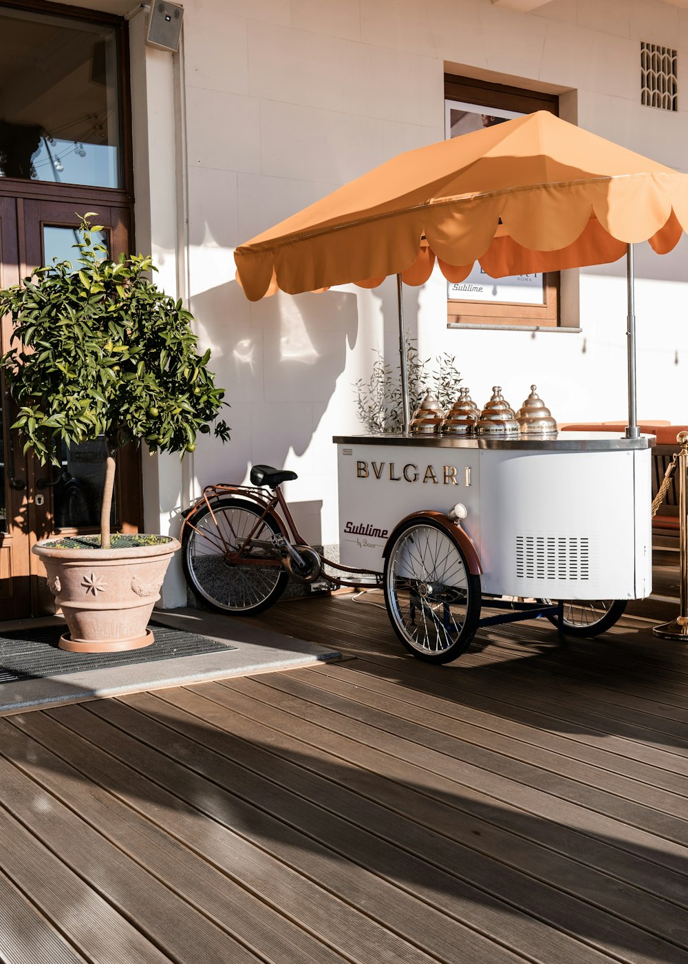 an ice cream cart sitting on a wooden deck