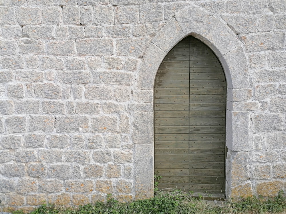 a stone building with a wooden door and window