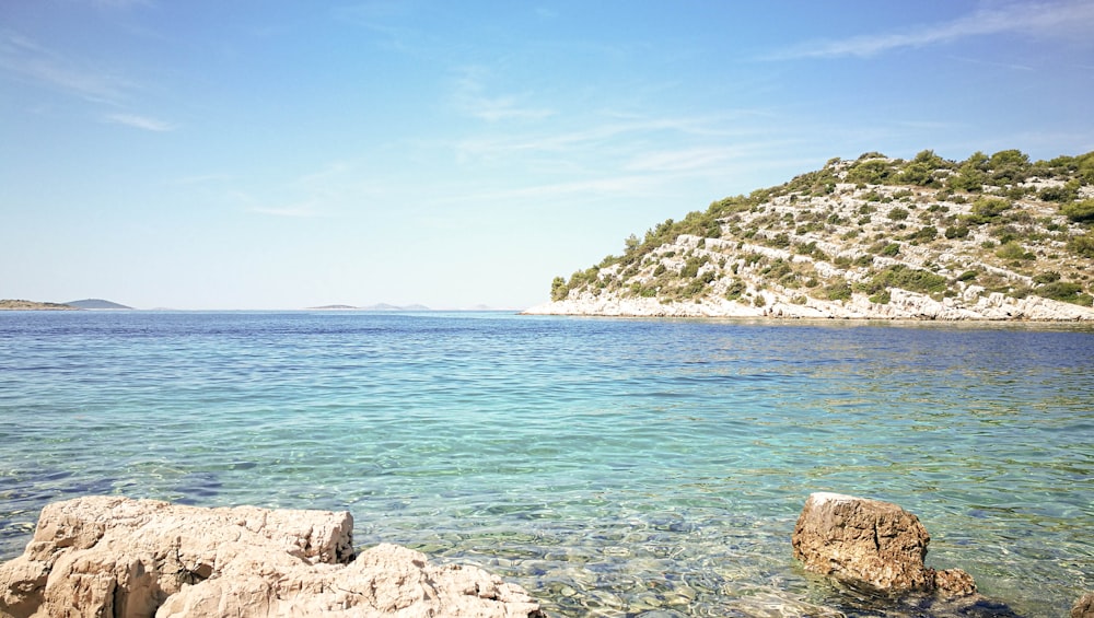 a large body of water with a small island in the background