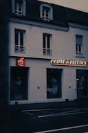 a white building with a red sign on the front of it