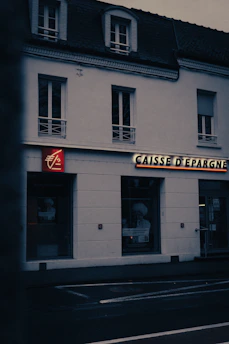 a white building with a red sign on the front of it