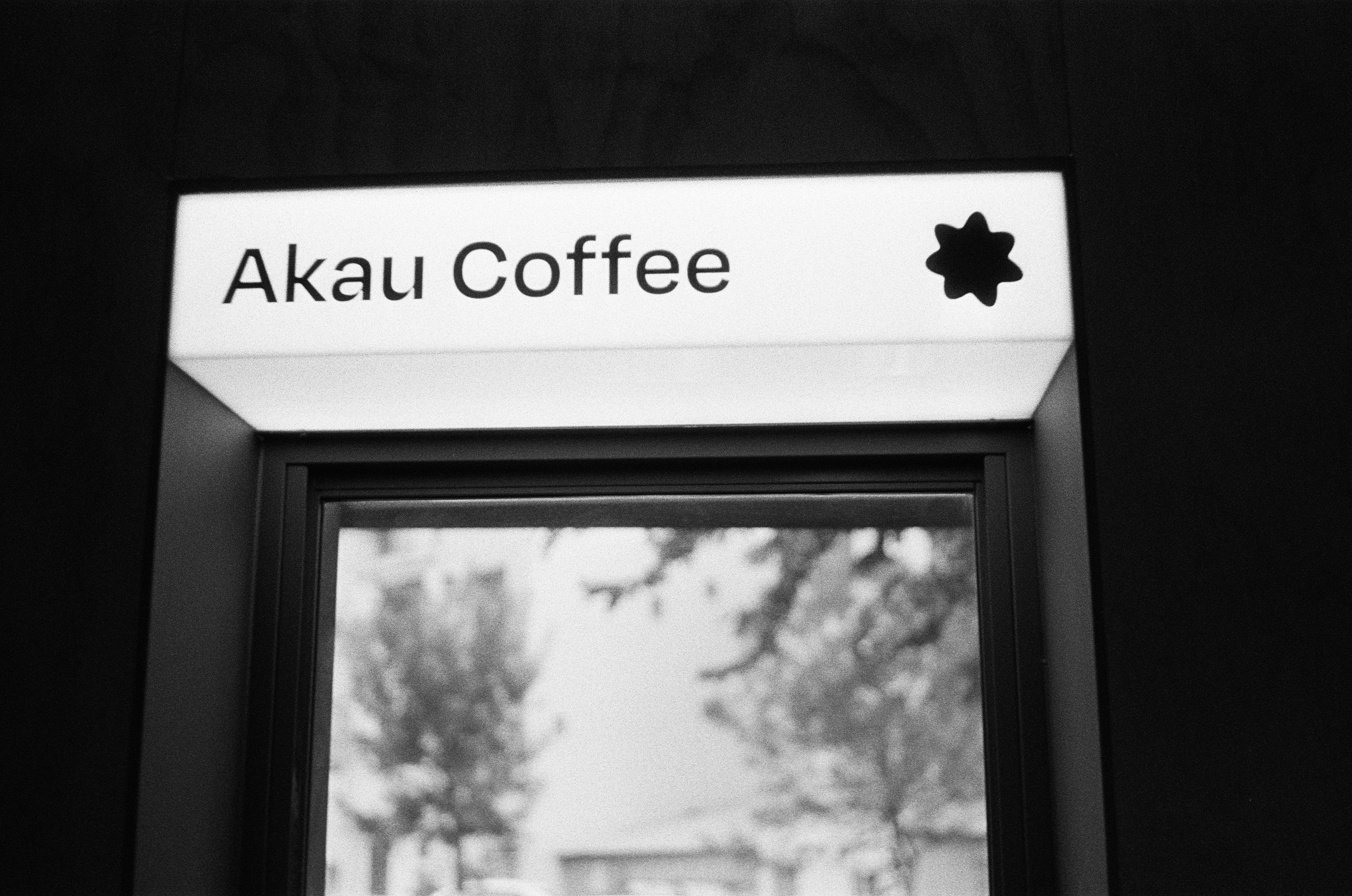 a black and white photo of a coffee shop sign