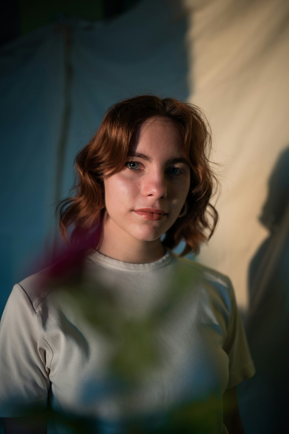 a woman with red hair and a white shirt