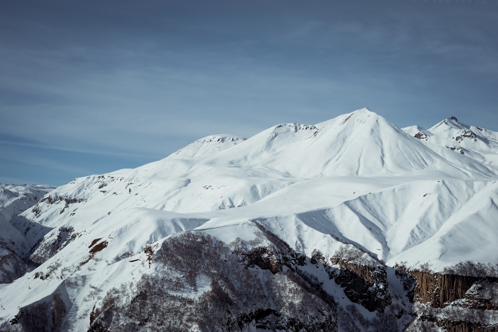 a mountain covered in snow under a blue sky