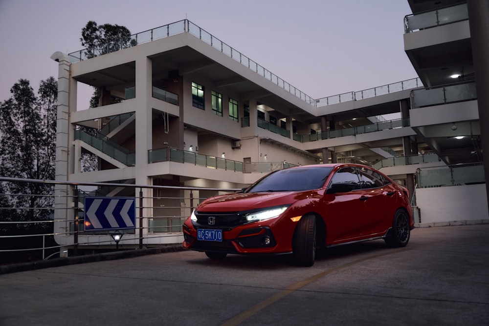 a red car parked in front of a building