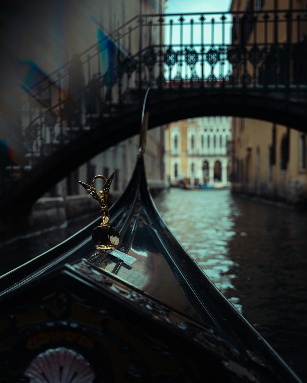 a gondola in a canal with a bridge in the background