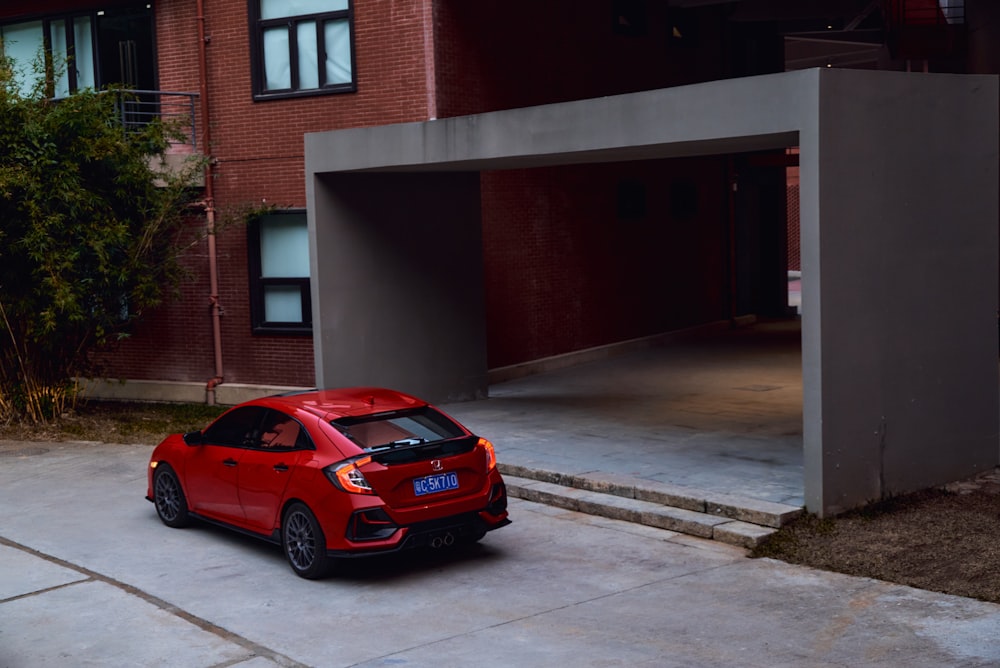 a red car parked in front of a building