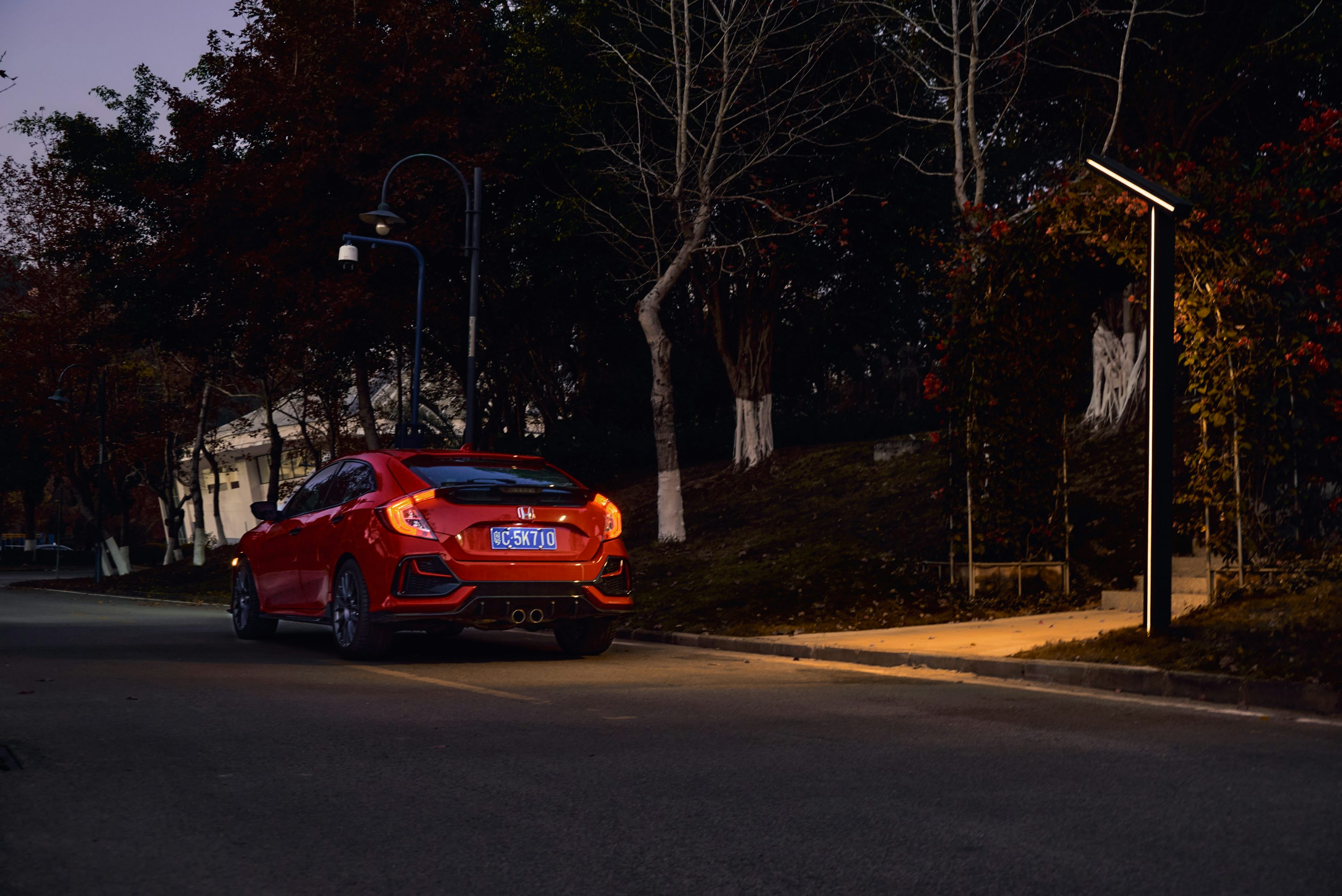 a red car parked on the side of the road