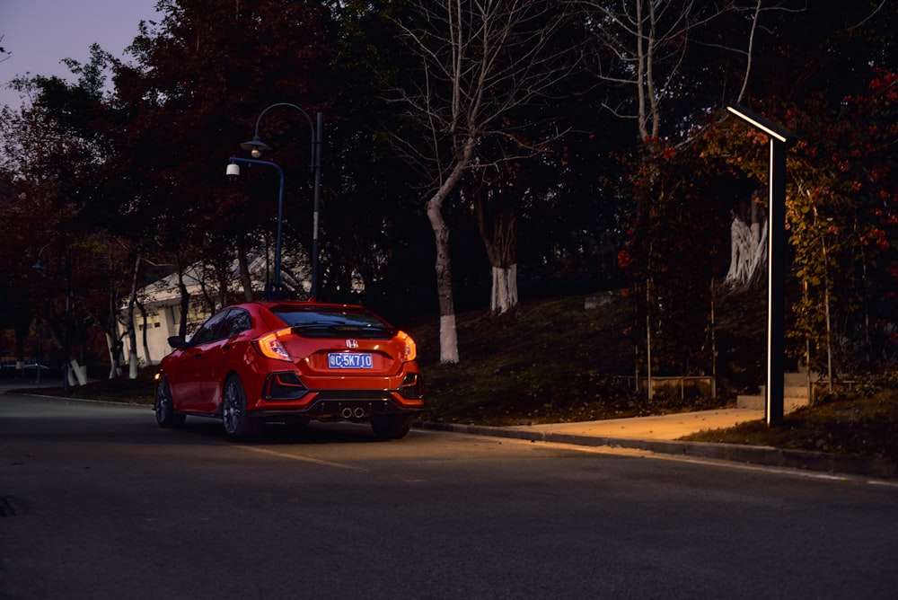 a red car parked on the side of the road