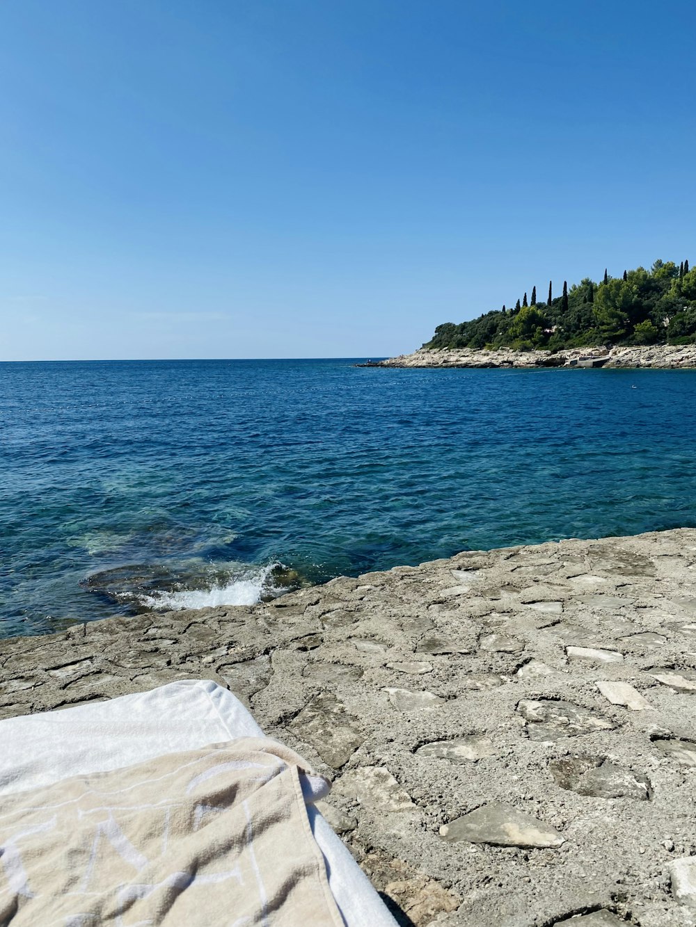 a view of a body of water from a rocky shore