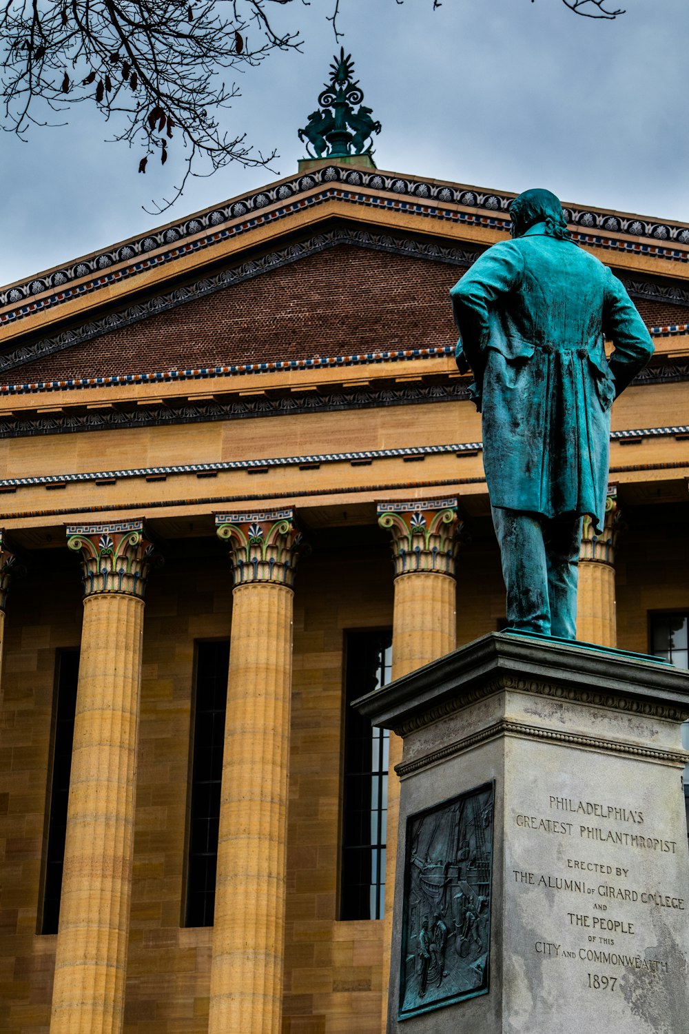 a statue of a man standing in front of a building