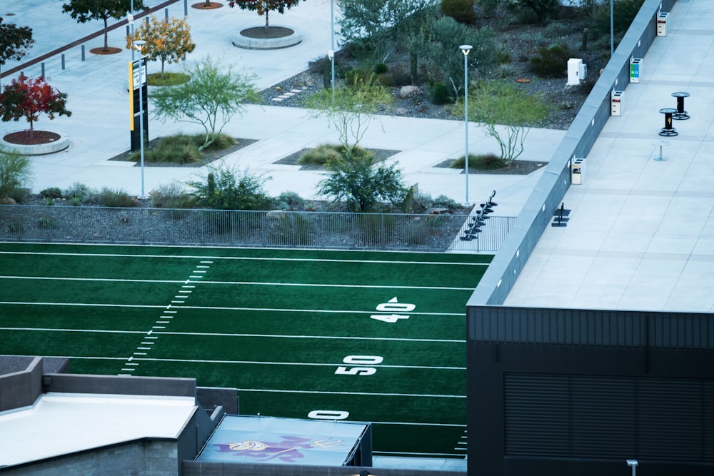 an aerial view of a football field and a parking lot