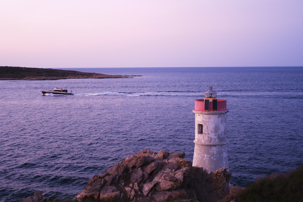 a light house sitting on top of a rock near the ocean