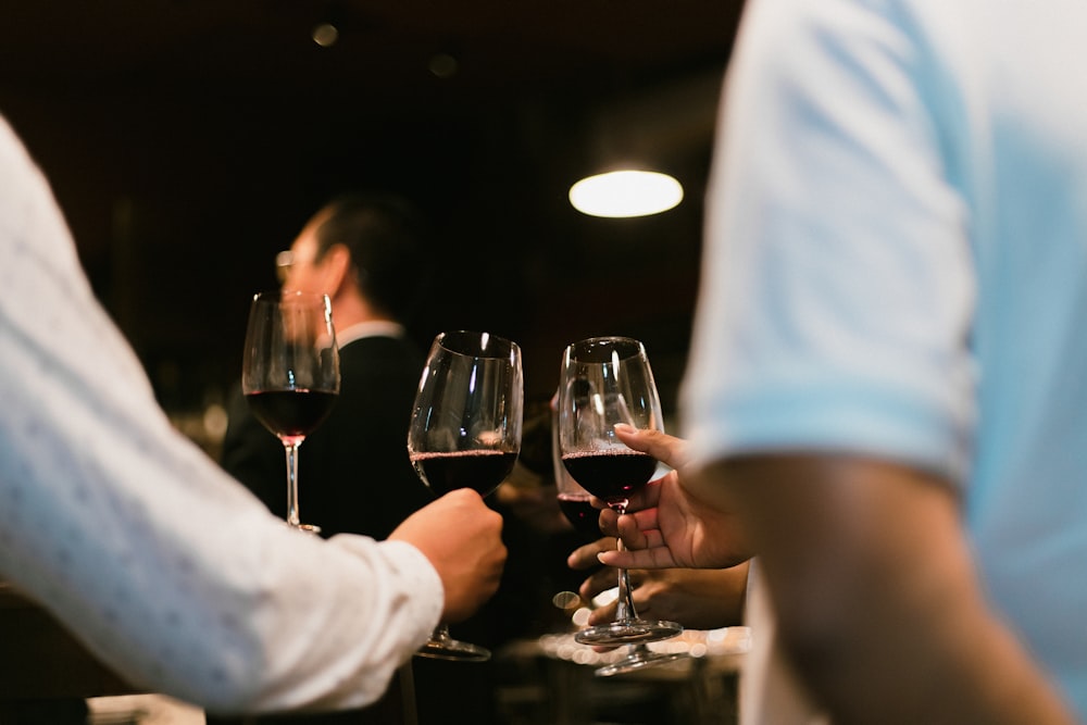 a group of people holding glasses of wine