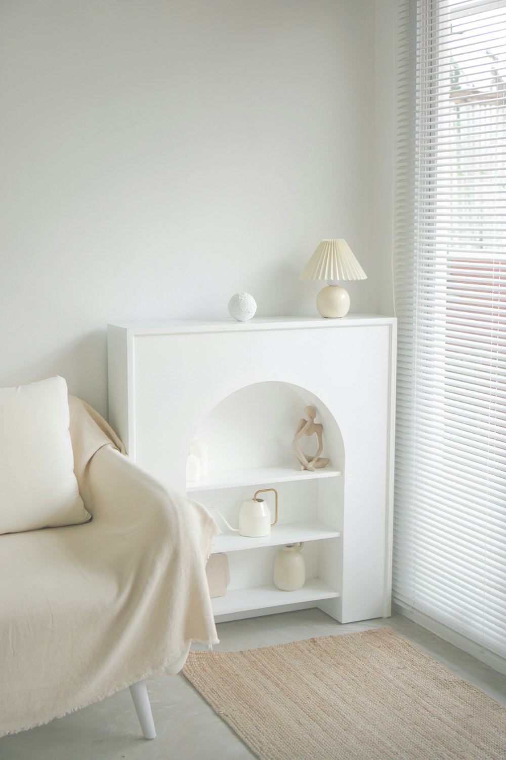 a bedroom with a white bed and a white shelf