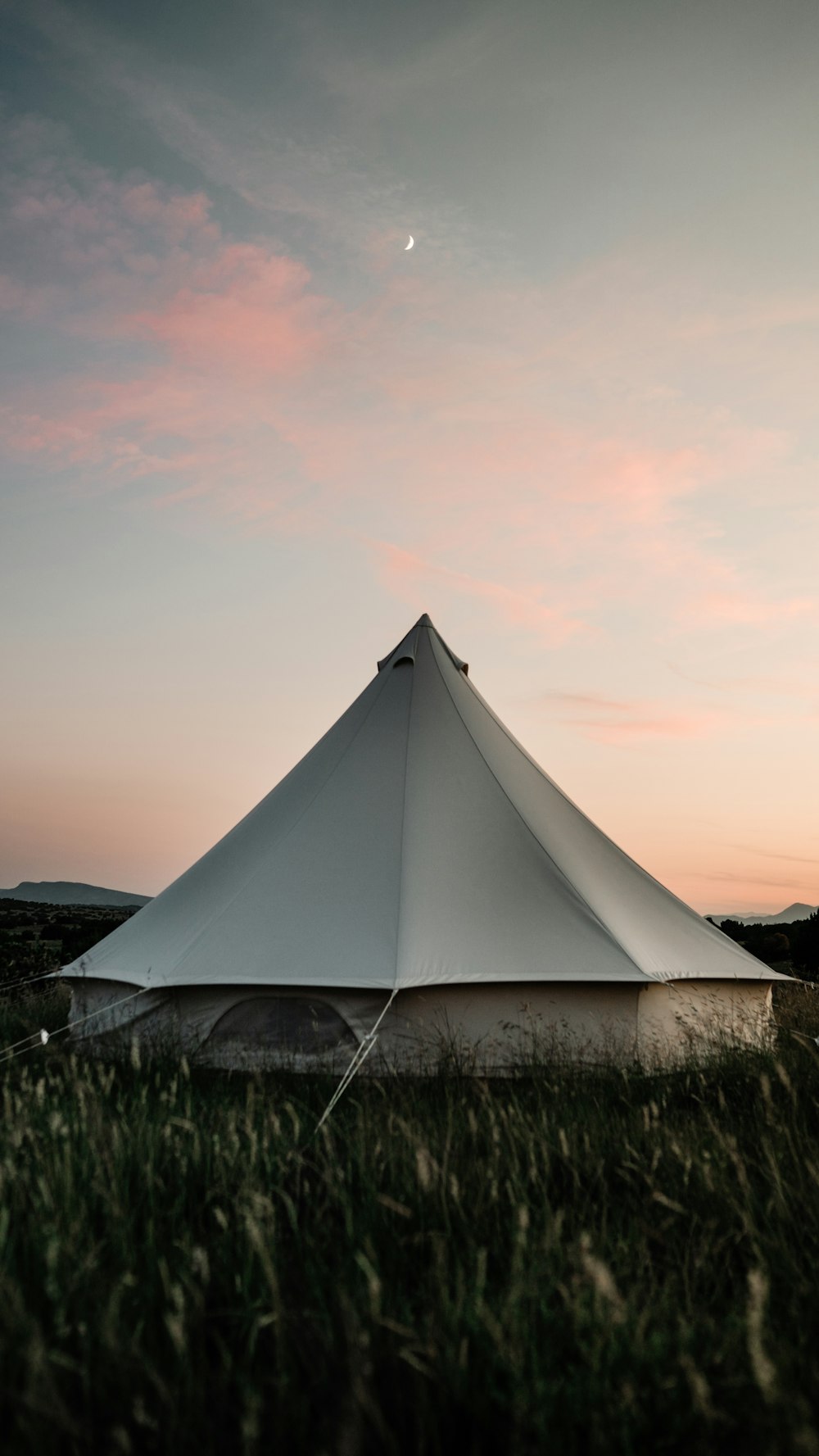 a large white tent sitting in the middle of a field