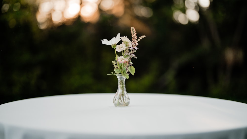 a small vase with flowers on a table