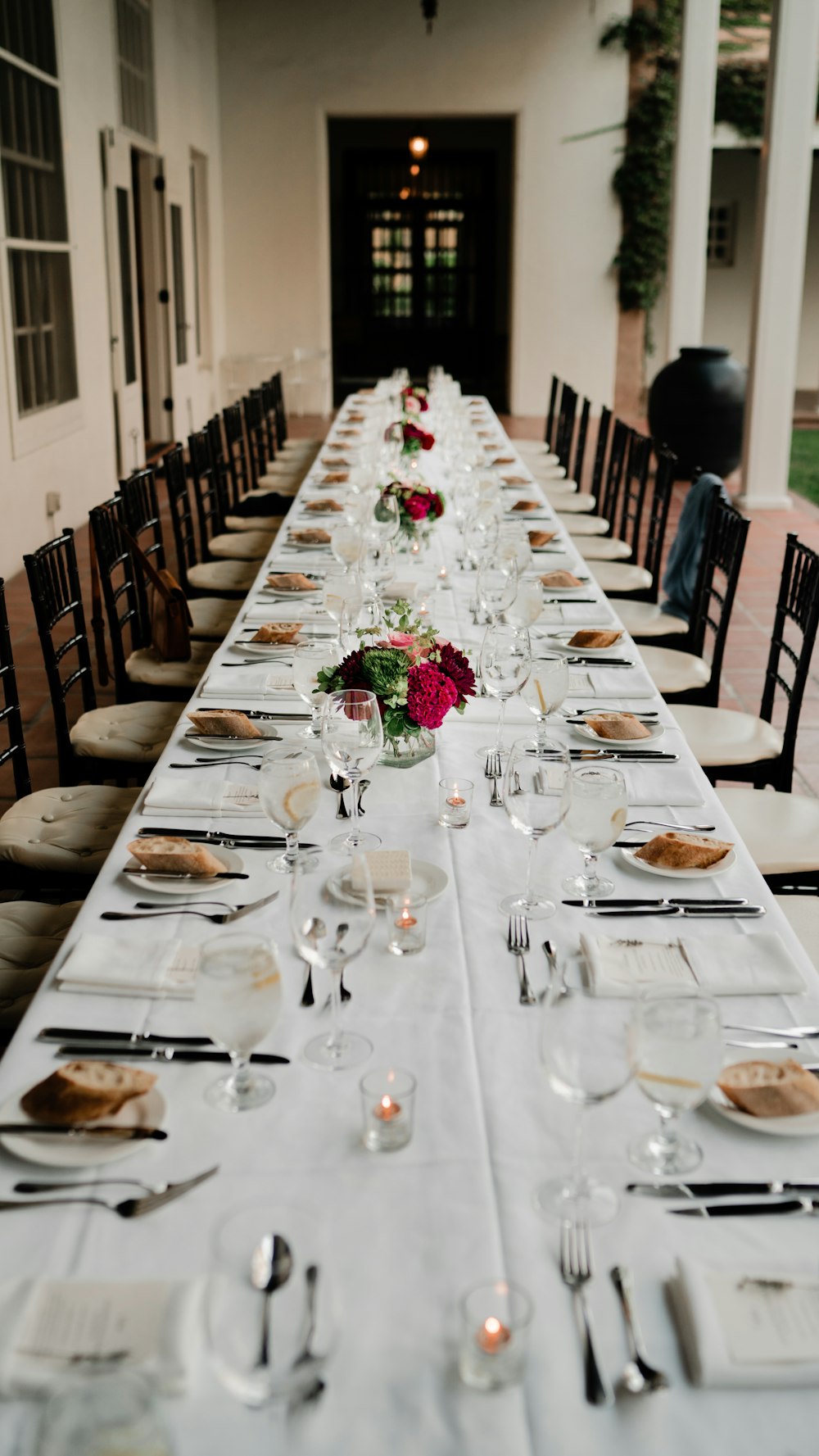 a long table is set for a formal dinner