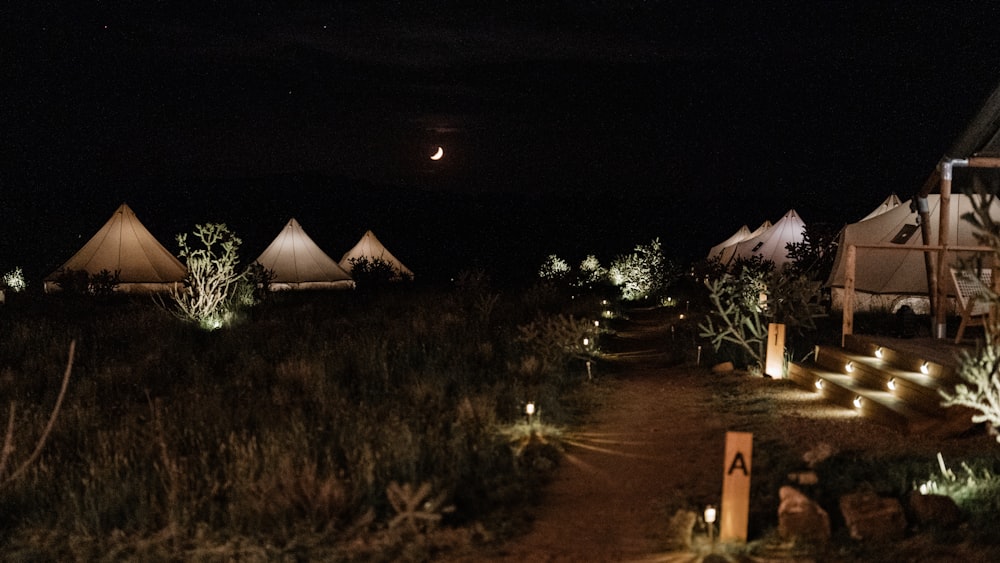 a group of tents lit up at night