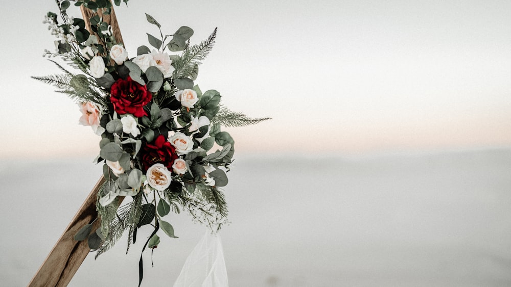 a wedding arch decorated with flowers and greenery