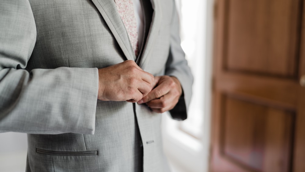 a close up of a person wearing a suit and tie