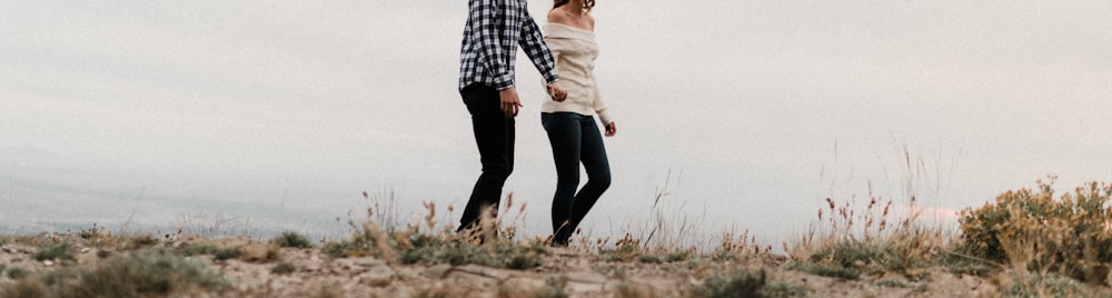 a couple of people standing on top of a hill