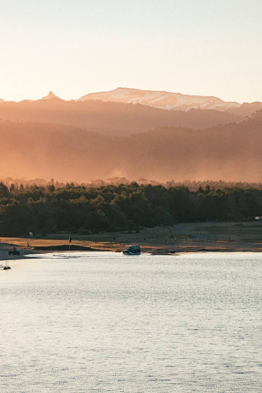 a body of water with mountains in the background