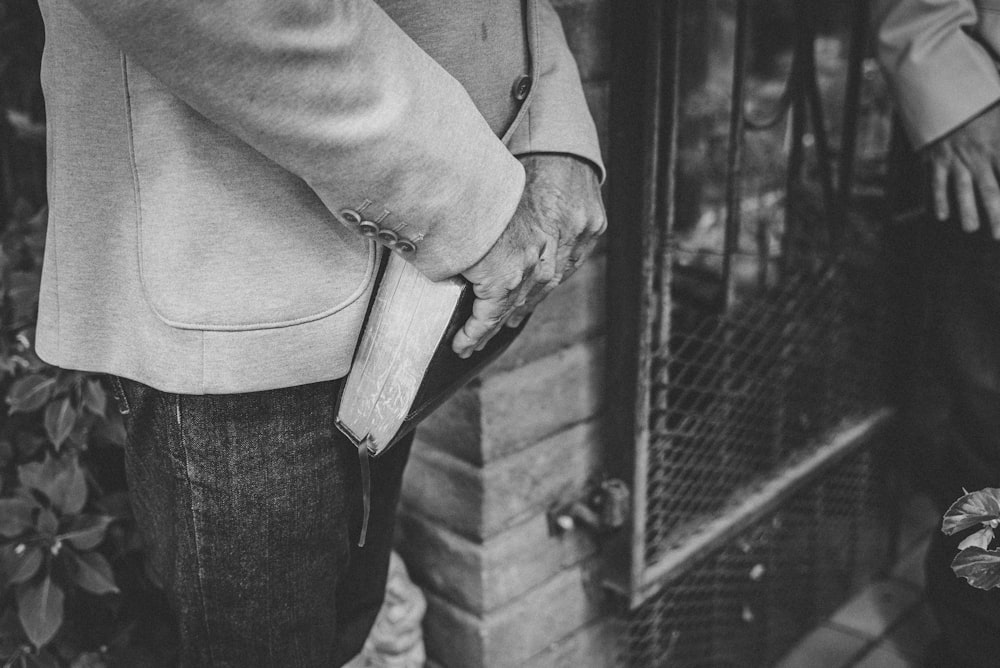 a black and white photo of a person holding a knife