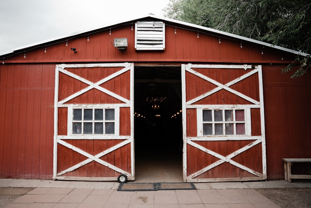 a red barn with a white door and windows