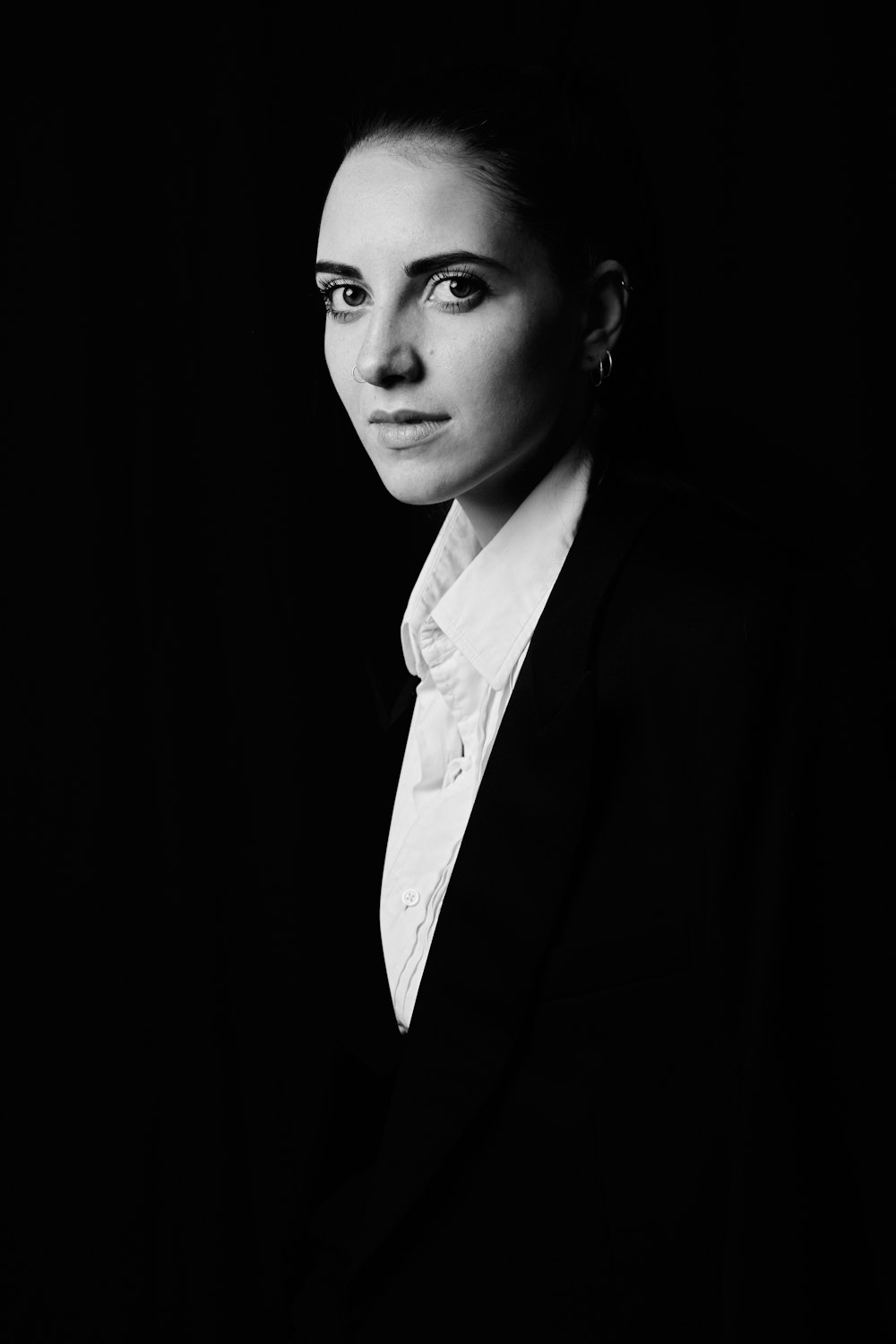 a black and white photo of a woman in a suit