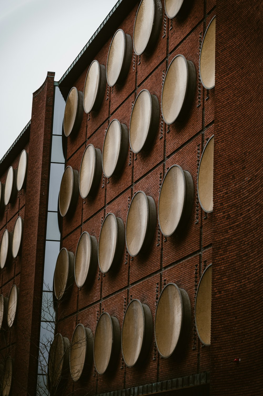 a red brick building with a lot of white circles on it