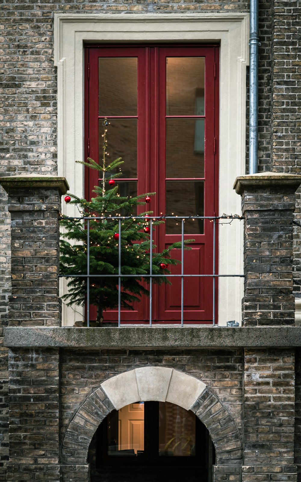 a small christmas tree sitting on top of a brick wall