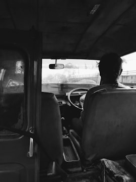 a man sitting in the driver's seat of a truck