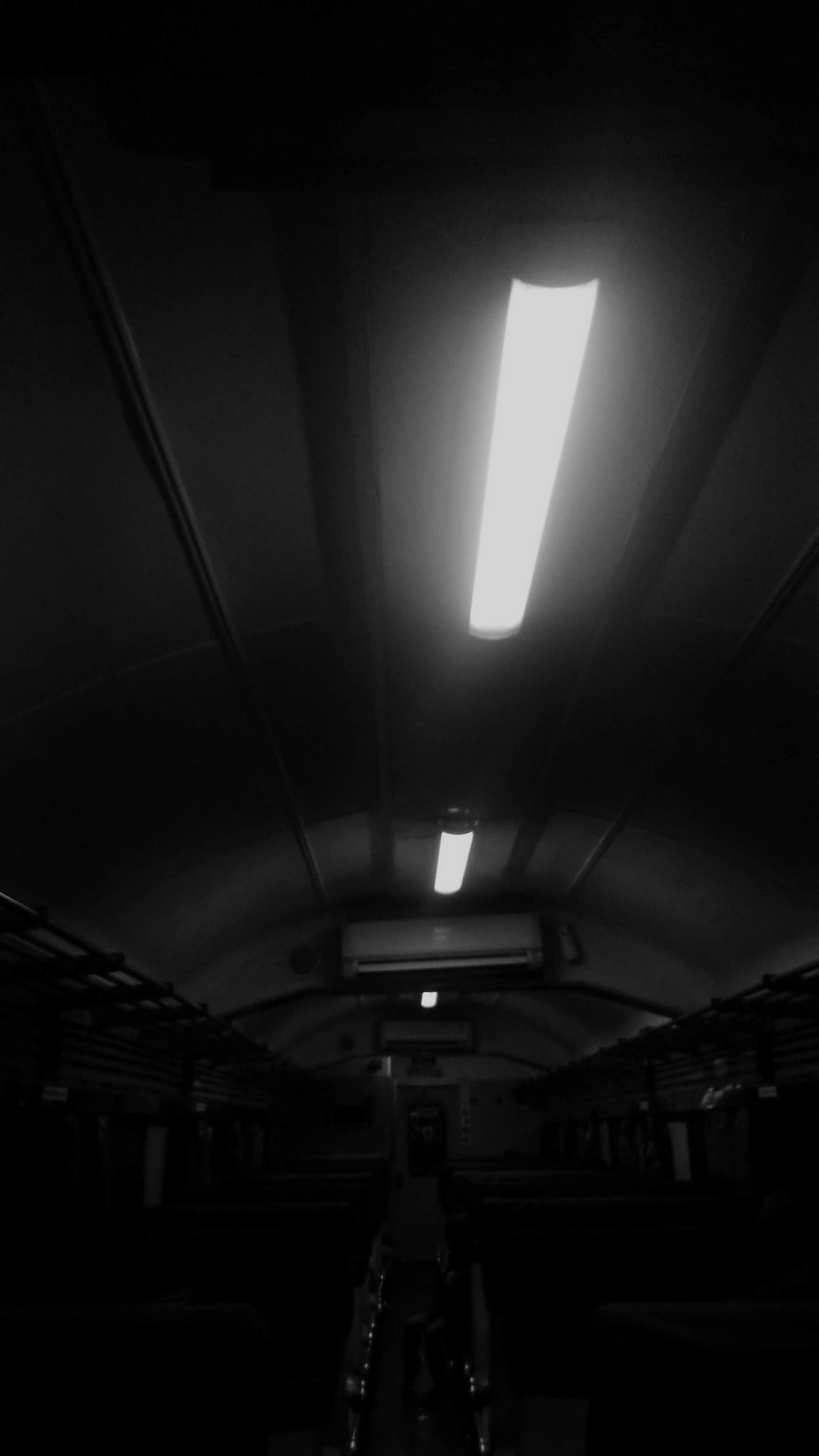 a black and white photo of a light in a dark room