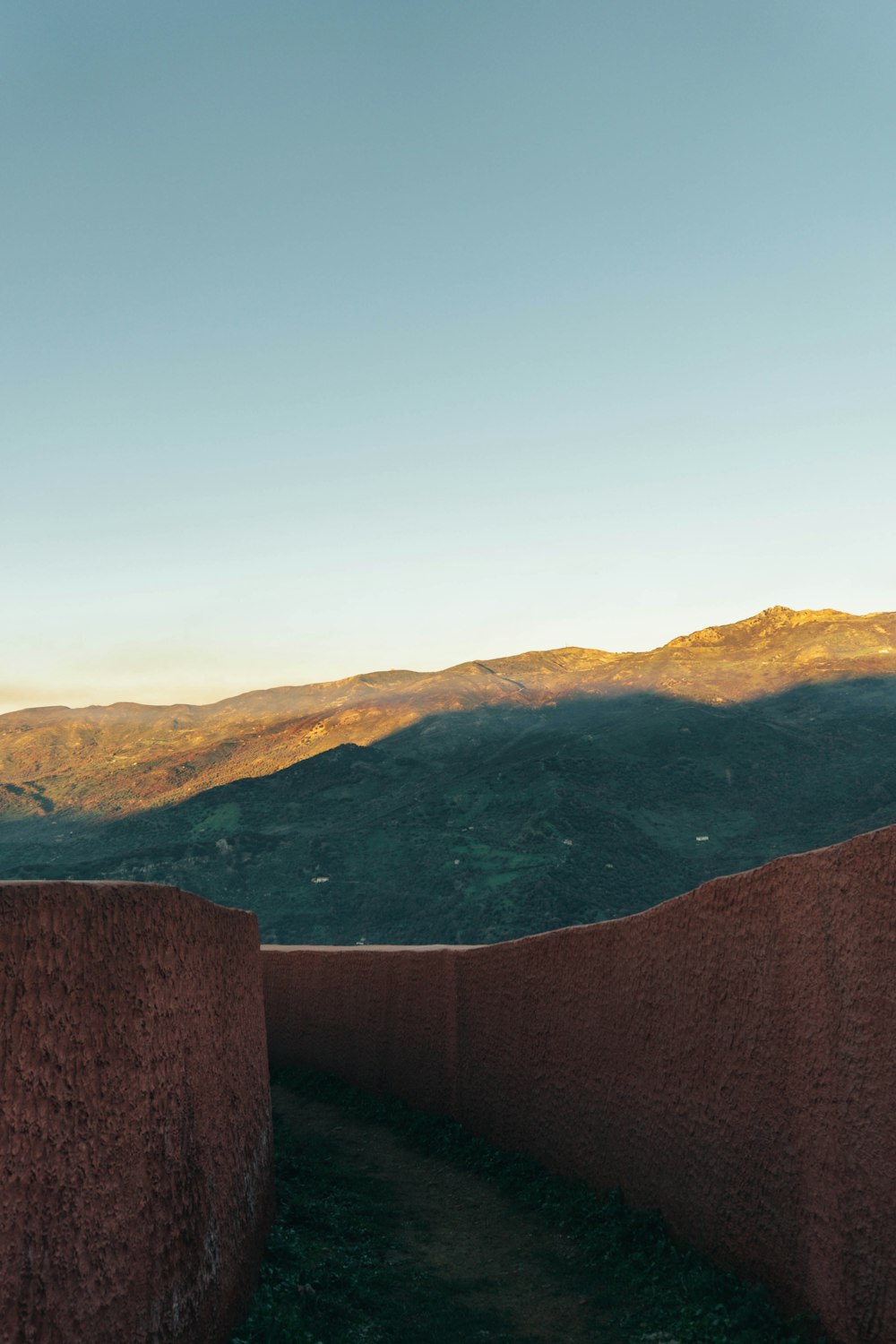 a man riding a skateboard on top of a stone wall