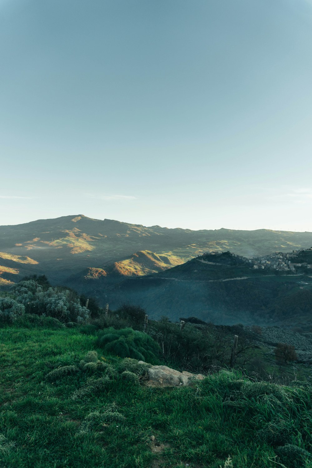 a view of a valley with mountains in the background