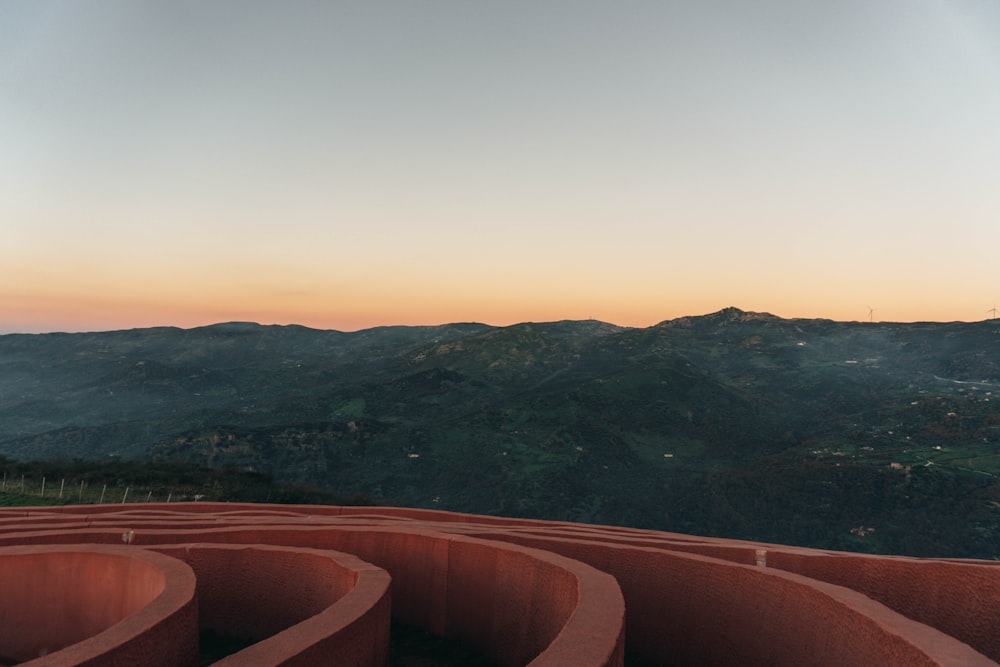 a view of a mountain range from the top of a hill