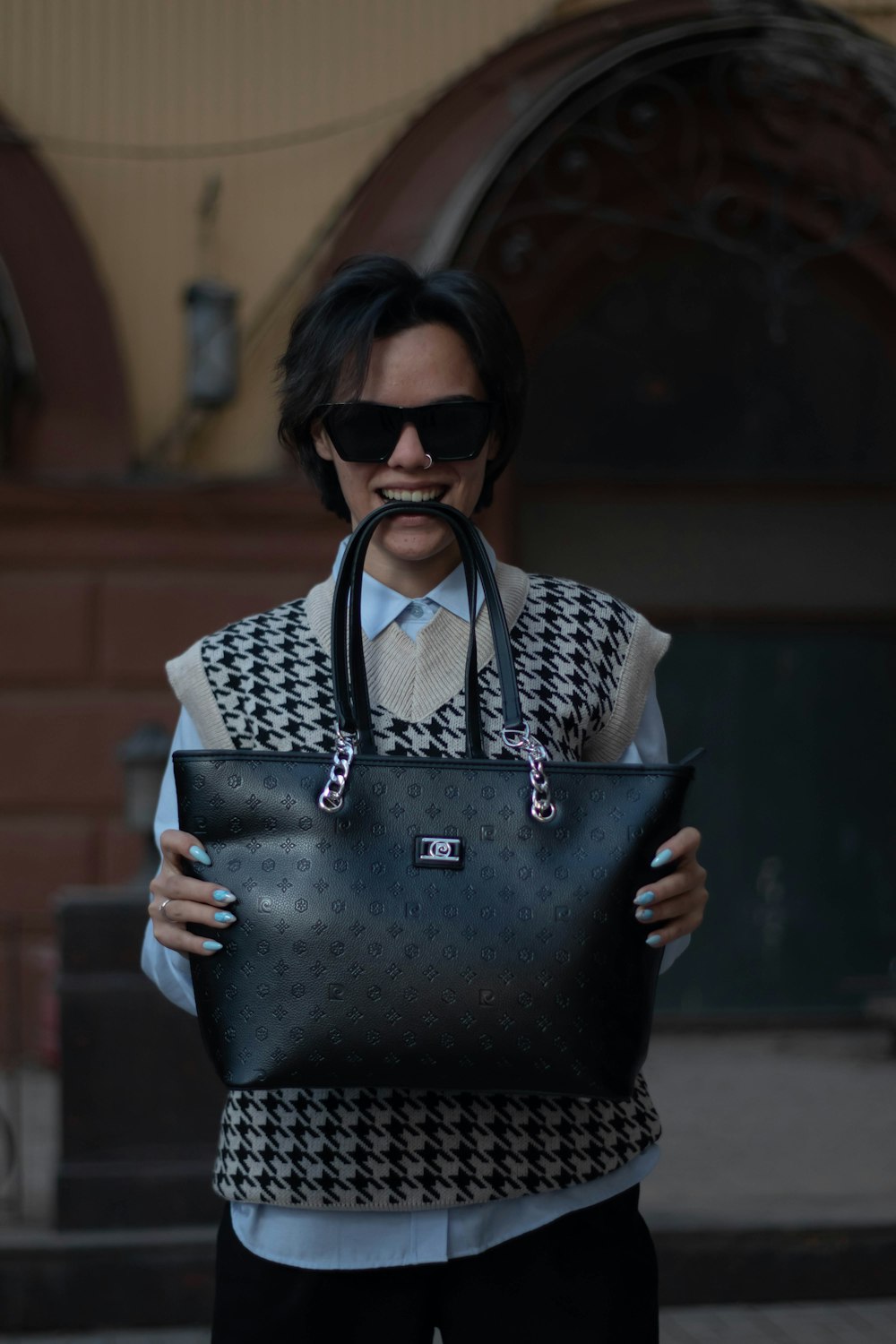 a man holding a black and white bag