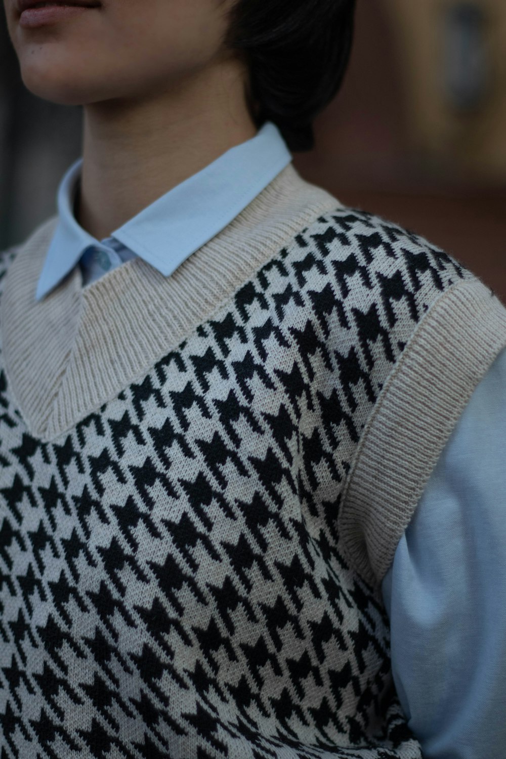 a woman wearing a sweater and a tie